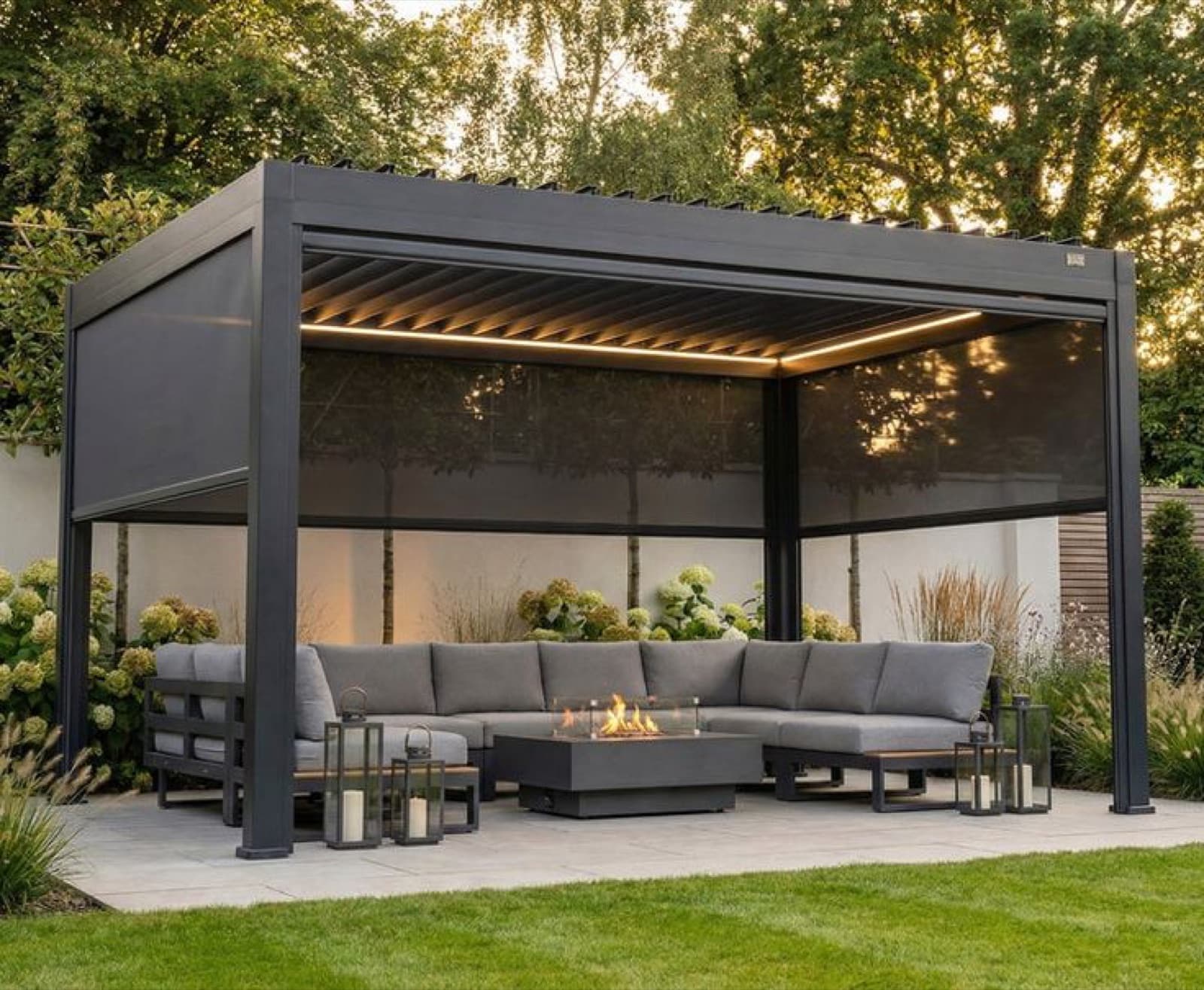 Aluminum louvered pergola with outdoor seating and a built-in fire table in a garden